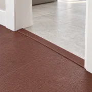 Chestnut T-molding transition — installed view