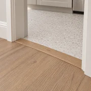 Honey Oak T-molding transition — installed view