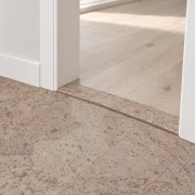 Travertine T-molding transition — installed view