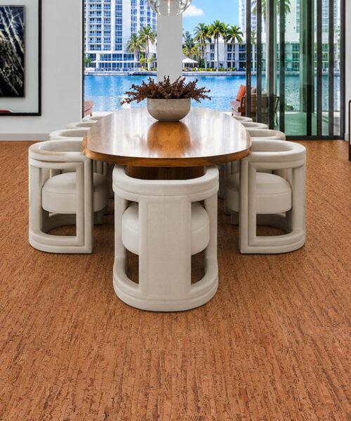 Elegant waterfront dining room showcasing Amber Streak 12mm cork flooring with a natural streaked cork pattern.
