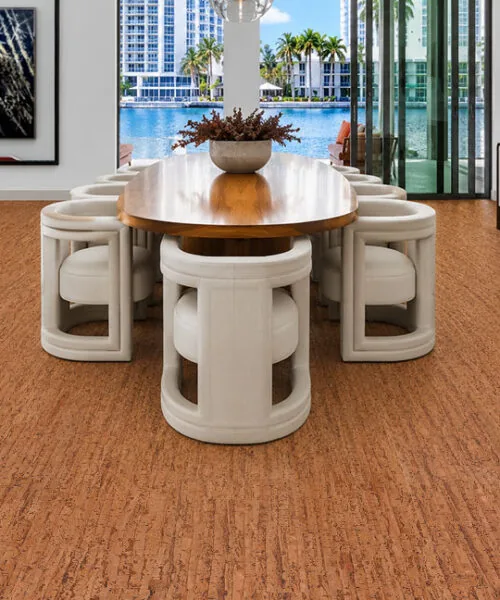 Elegant waterfront dining room showcasing Amber Streak 12mm cork flooring with a natural streaked cork pattern.