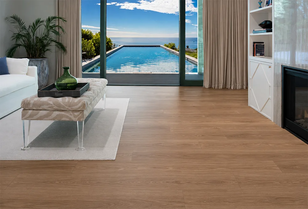 American Red Oak - 7/16" (11mm) - Swiss Design Cork Floating (FRed11) Durable wood-look Swiss cork flooring in a coastal living room with fireplace and ocean view
