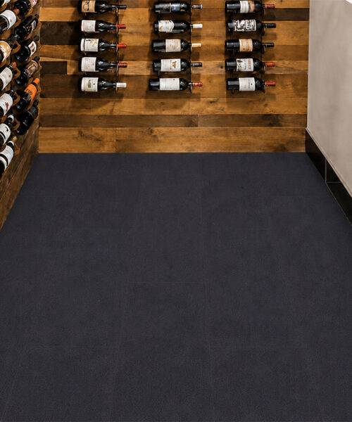 Dark Black Buffalo leather plank flooring in an upscale contemporary interior with a marble fireplace, built-in media wall and expansive glass doors.