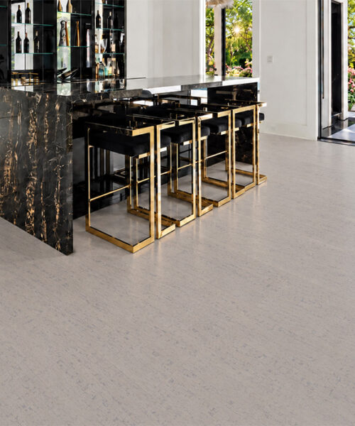 Bleached Birch 12mm floating cork flooring in milky gray tones frames a black marble home bar.