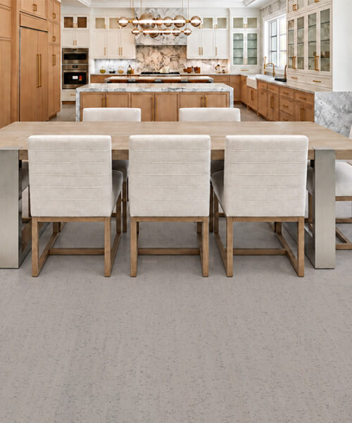 Bleached Birch off-white cork flooring with subtle gray grain surrounds a long dining table and wood cabinetry.