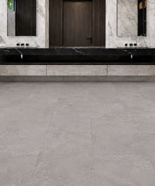 Bright Stone Swiss TechSlate flooring adds a cool gray stone-look finish to a contemporary bathroom with a freestanding bathtub and double vanity.
