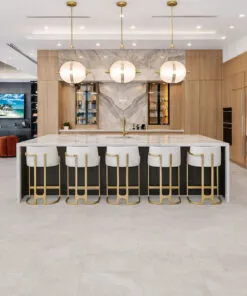 Neutral stone-look flooring enhancing a luxury kitchen with spacious island seating