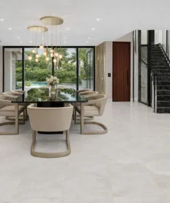 Elegant dining area featuring seamless stone-style flooring and open design