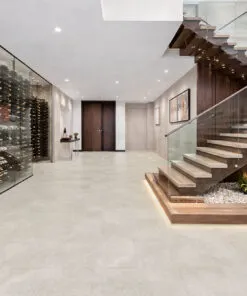 Large-format stone-style flooring flowing through a contemporary hallway and staircase
