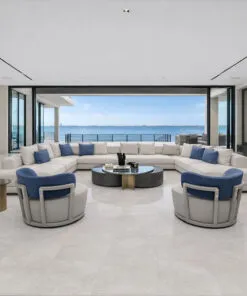 Open living room with expansive windows and light stone flooring throughout