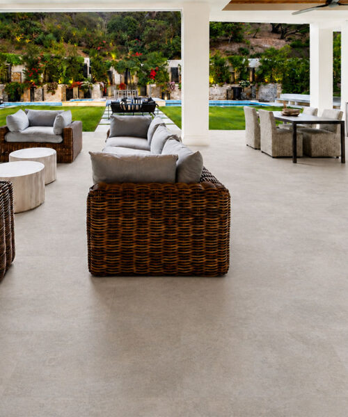 Bris Stone - 7/16" (11mm) - Swiss Design Cork Floating (FBsSt11) Pale gray Bris Stone floating cork flooring unifies a poolside living and dining space with wicker sofas.