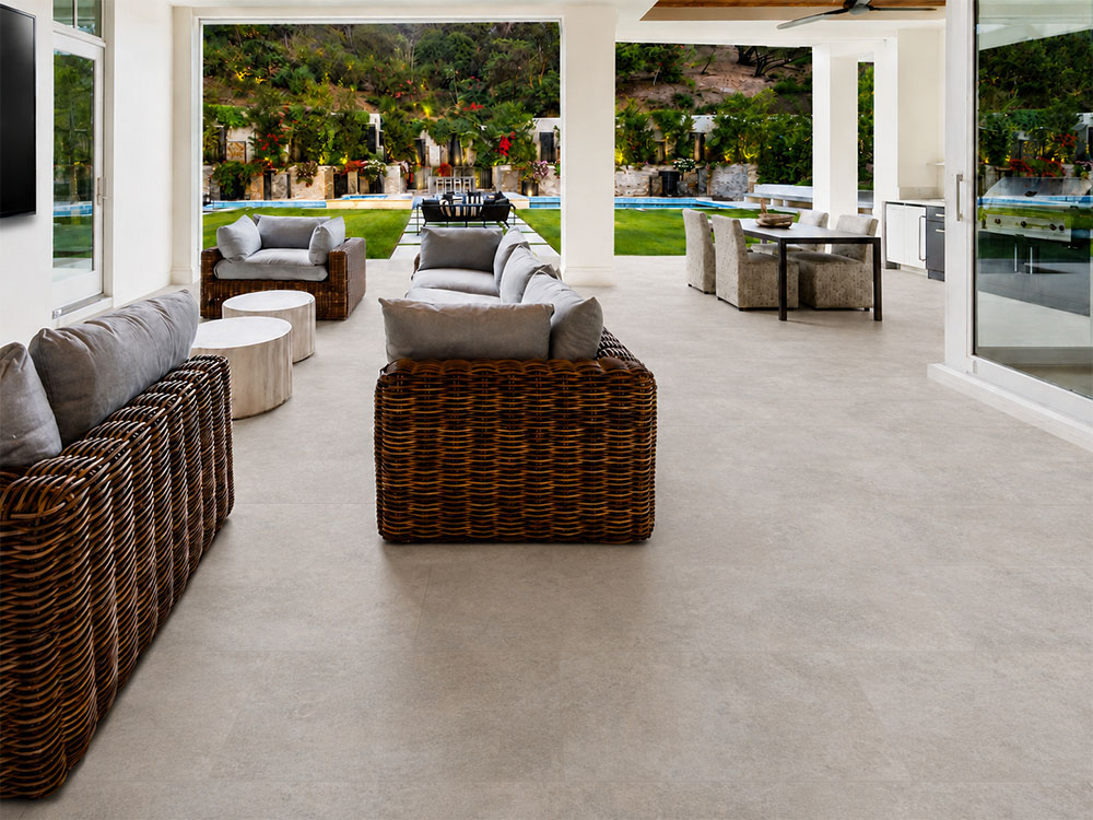 Bris Stone - 7/16" (11mm) - Swiss Design Cork Floating (FBsSt11) Pale gray Bris Stone floating cork flooring unifies a poolside living and dining space with wicker sofas.