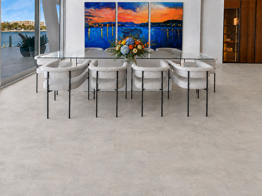 Bris Stone - 7/16" (11mm) - Swiss Design Cork Floating (FBsSt11) Bris Stone gray-beige stone-look cork flooring fills a waterfront dining room with white upholstered chairs.