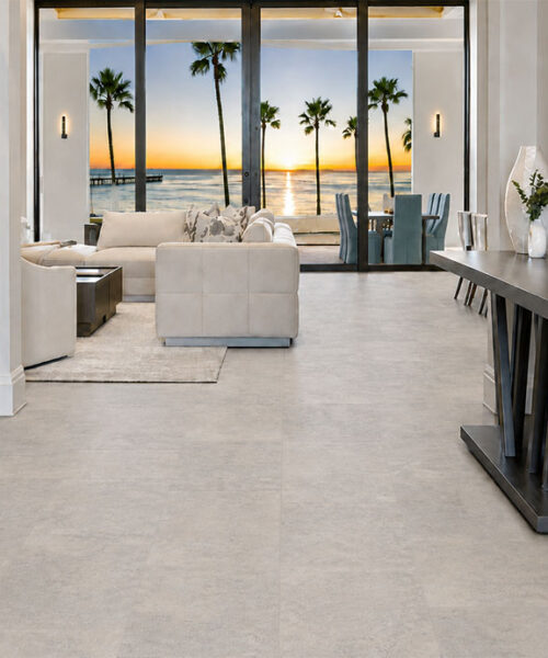 Bris Stone - 7/16" (11mm) - Swiss Design Cork Floating (FBsSt11) Bris Stone Swiss Design cork flooring in pale limestone tones leads toward a sunset-view living room.