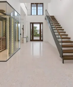 Bright entryway with floating staircase and ceramic marble cork flooring