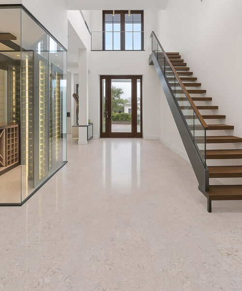 Bright entryway with floating staircase and ceramic marble cork flooring
