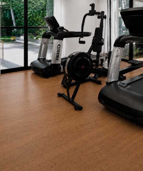 Natural Cherry Line cork floor planks complement treadmills and exercise equipment in a modern home gym.