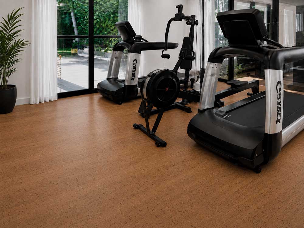 Cherry Line - 7/16" (11mm) - Swiss Real Cork Floating (FCHL11) Natural Cherry Line cork floor planks complement treadmills and exercise equipment in a modern home gym.