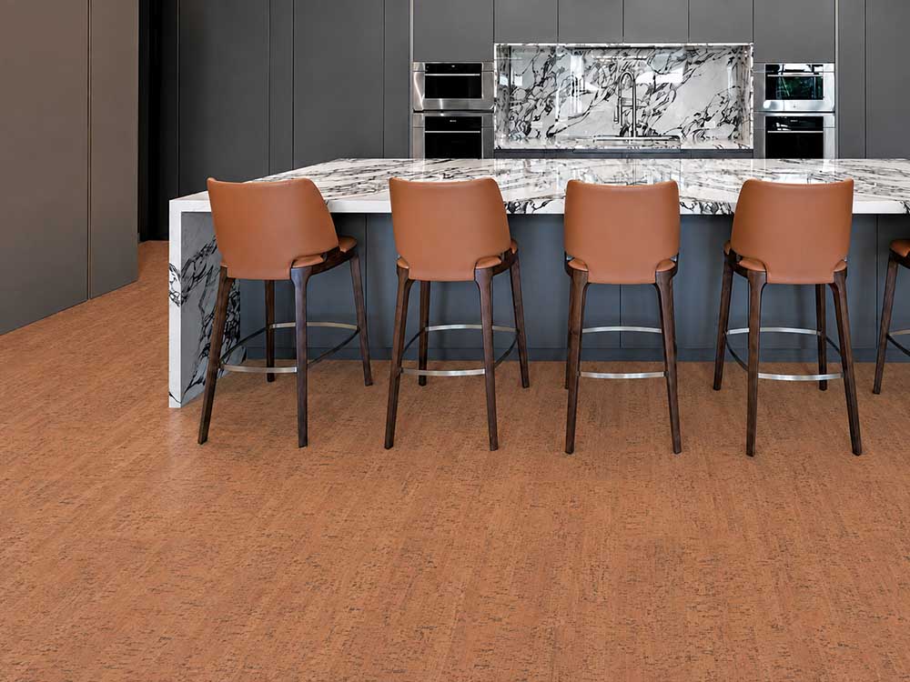 Cherry Line - 7/16" (11mm) - Swiss Real Cork Floating (FCHL11) Cherry Line Swiss cork flooring brings reddish-brown texture to a kitchen with marble counters and barstools.