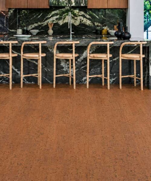 Cherry Line - 7/16" (11mm) - Swiss Real Cork Floating (FCHL11) Cherry Line floating cork floor planks frame a dark marble kitchen island with natural wood stools.