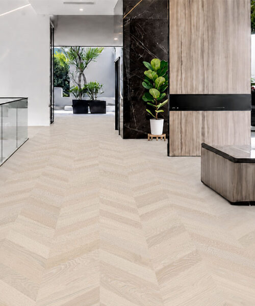 Clara Chevron - 7/16″ (11mm) – Swiss Design Cork Floating (FCla11) Light Clara Chevron cork floor planks form a soft chevron pattern across a contemporary upper-level hallway.