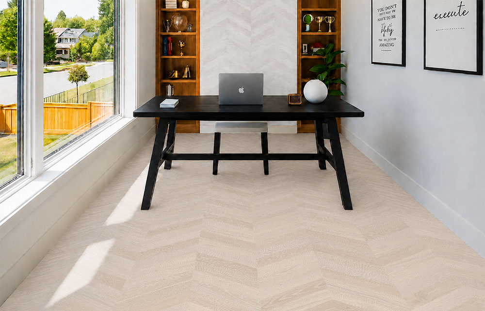 Clara Chevron - 7/16″ (11mm) – Swiss Design Cork Floating (FCla11) Clara Chevron cork flooring for an office features pale gray chevrons beneath a black desk and shelving.