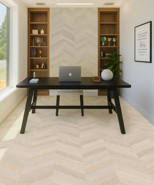Clara Chevron - 7/16″ (11mm) – Swiss Design Cork Floating (FCla11) Bright home office with a large desk and light Clara Chevron cork flooring arranged in a chevron pattern.