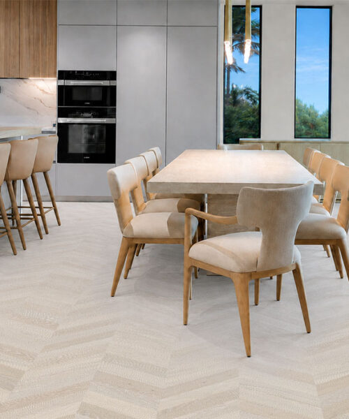 Clara Chevron - 7/16″ (11mm) – Swiss Design Cork Floating (FCla11) Pale gray Clara Chevron floating cork flooring unifies a spacious kitchen and dining area with wood accents.