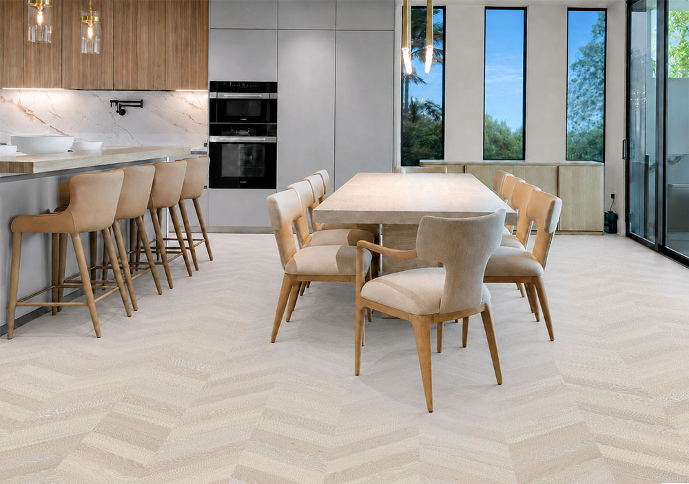 Clara Chevron - 7/16″ (11mm) – Swiss Design Cork Floating (FCla11) Pale gray Clara Chevron floating cork flooring unifies a spacious kitchen and dining area with wood accents.