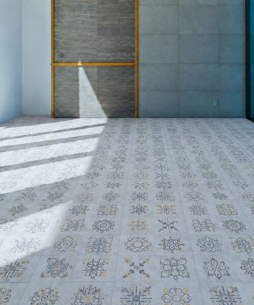 Classic Porcelain - 19/64" (7.5mm) - Swiss Techslate (MCPor7.5) Classic Porcelain Swiss TechSlate light gray mineral-based flooring with repeating floral medallions in a sunlit contemporary commercial interior.