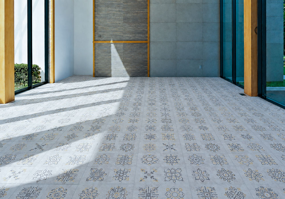 Classic Porcelain - 19/64" (7.5mm) - Swiss Techslate (MCPor7.5) Classic Porcelain Swiss TechSlate light gray mineral-based flooring with repeating floral medallions in a sunlit contemporary commercial interior.