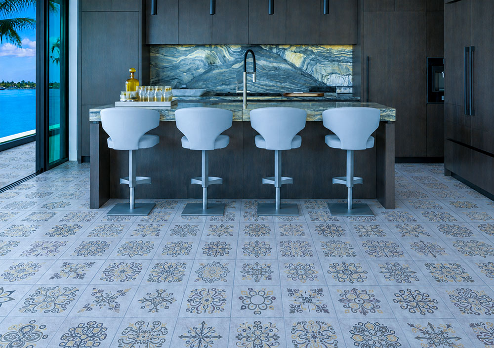 Classic Porcelain - 19/64" (7.5mm) - Swiss Techslate (MCPor7.5) Classic Porcelain Swiss TechSlate click-lock flooring in light gray with floral medallion prints across a modern kitchen with island seating.