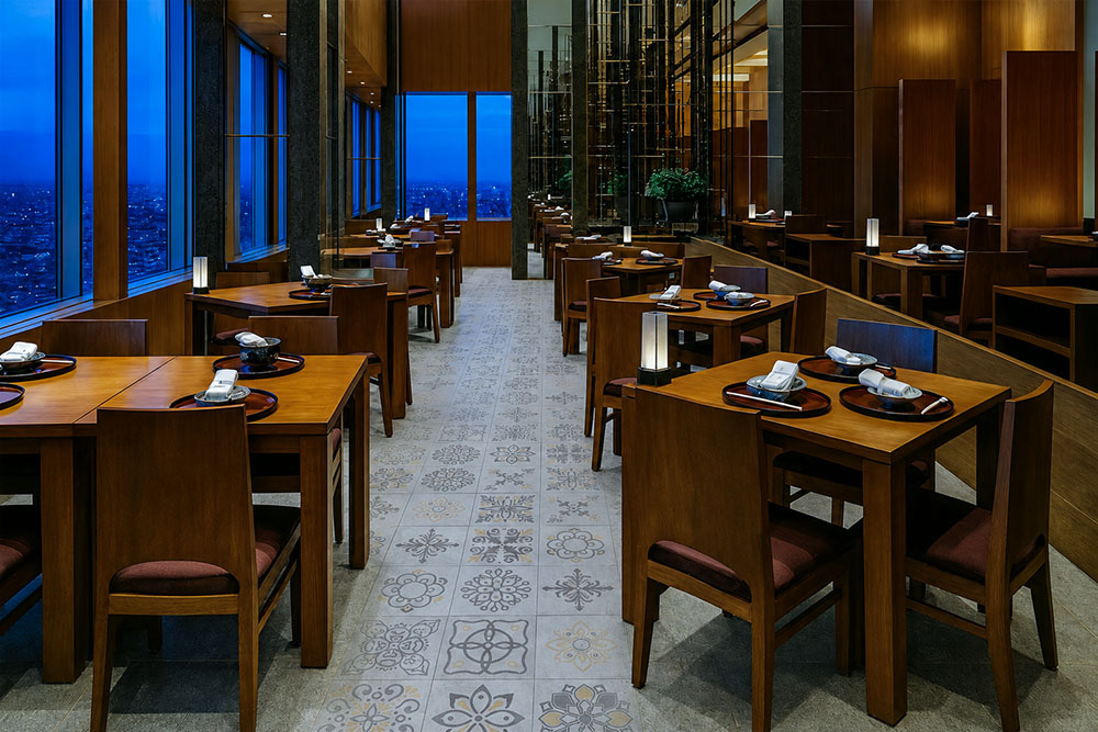 Classic Porcelain - 19/64" (7.5mm) - Swiss Techslate (MCPor7.5) Classic Porcelain Swiss TechSlate commercial-grade flooring in light gray with repeating floral and medallion designs in a restaurant dining room.