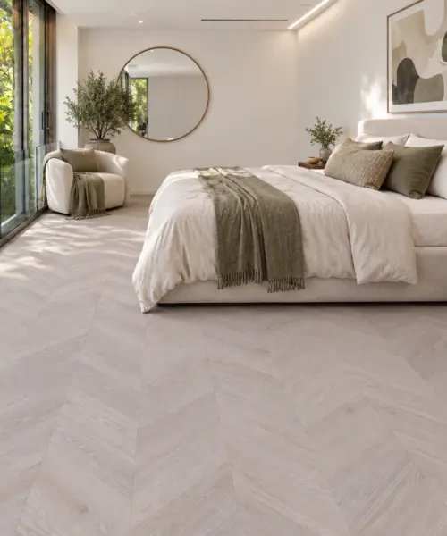 Clara Chevron installed flooring in a furnished daylight interior; accurate product scale visualization (FCla11)