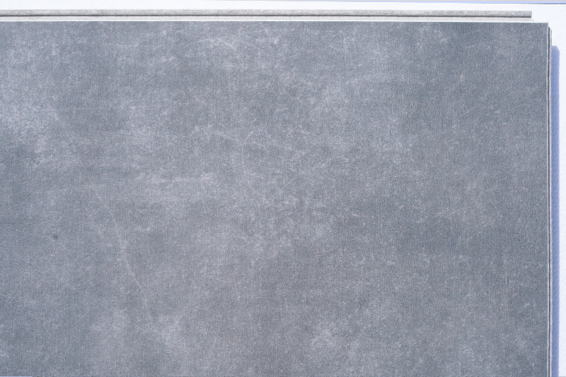 Concrete Alloy - 19/64" (7.5mm) - Swiss Techslate (MConA7.5) Concrete Alloy Swiss TechSlate flooring with a realistic gray concrete appearance, subtle cement texture, contemporary industrial style, and durable low-maintenance surface for residential and commercial interiors