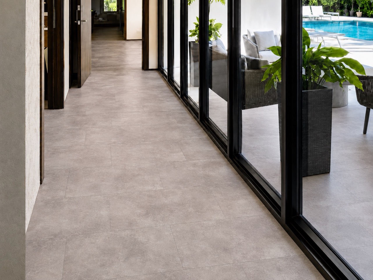 Copperstone Gray - 3/8" (9.5mm) - Forna Natural Composite Flooring with Waterproof Hydrowood Core (NCopG9.5) Copperstone Gray Natural Composite Flooring creates a soft stone-look surface in a bright corridor with floor-to-ceiling windows.