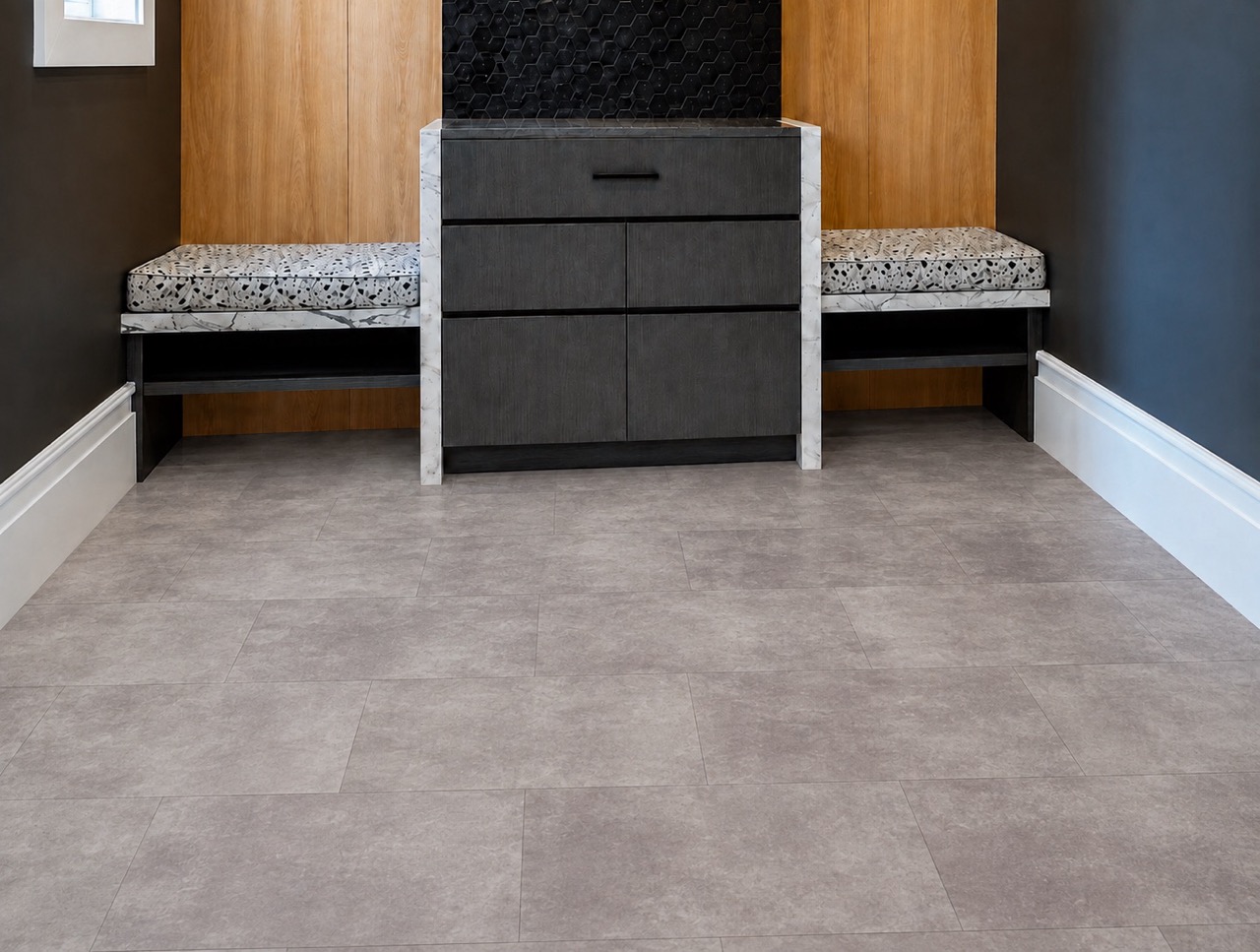 Copperstone Gray - 3/8" (9.5mm) - Forna Natural Composite Flooring with Waterproof Hydrowood Core (NCopG9.5) Copperstone Gray cork-backed flooring features subtle gray variation in a contemporary foyer with benches and dark accent walls.