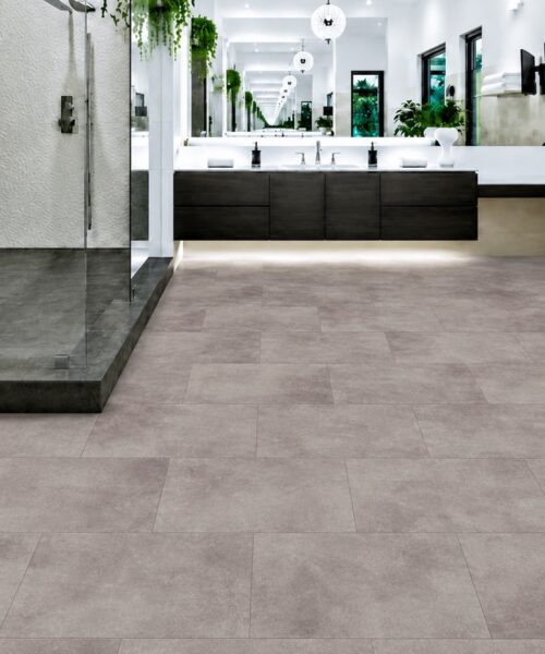 Copperstone Gray - 3/8" (9.5mm) - Forna Natural Composite Flooring with Waterproof Hydrowood Core (NCopG9.5) Copperstone Gray waterproof natural composite flooring complements a modern bathroom with dark shower tile and floating vanity.