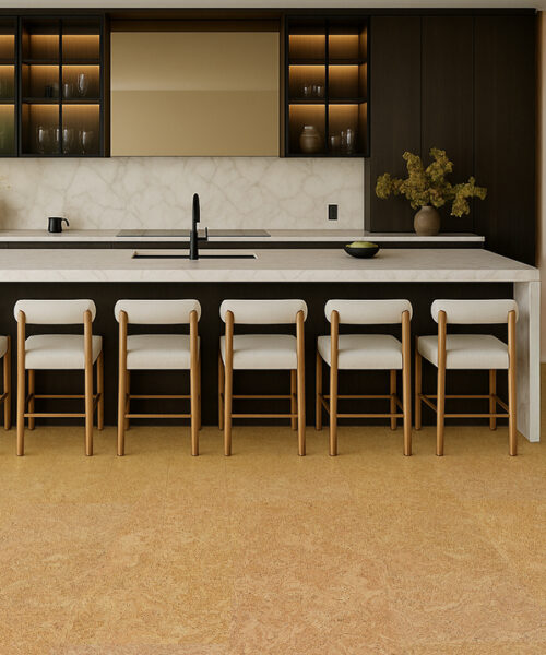 Stylish kitchen interior with a long island, soft lighting, and warm Desert Arable cork floors that add comfort and natural texture.