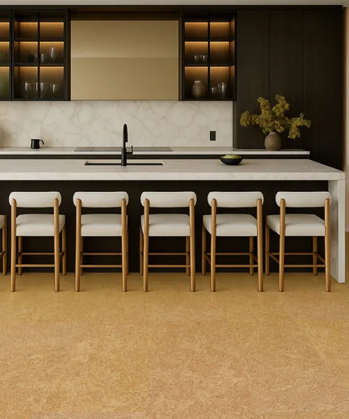 Stylish kitchen interior with a long island, soft lighting, and warm Desert Arable cork floors that add comfort and natural texture.