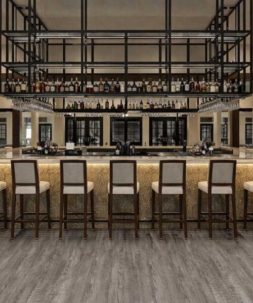 Stylish bar interior using Earthy Pine waterproof linoleum flooring for long-lasting commercial durability.