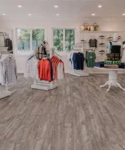 Retail showroom featuring Earthy Pine linoleum flooring, combining waterproof performance with natural wood aesthetics.