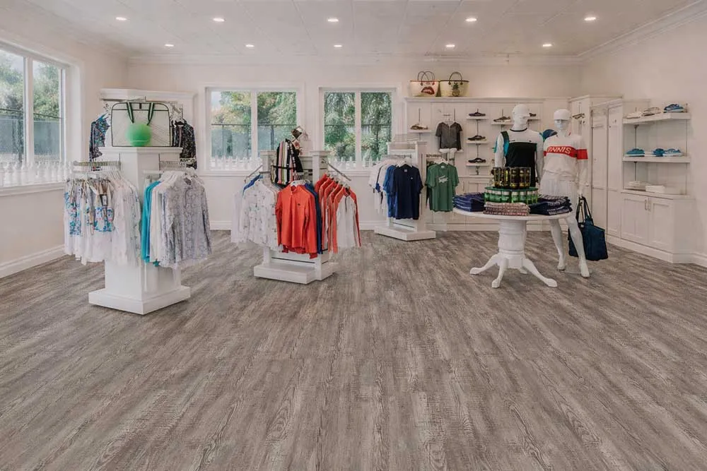 Earthy Pine - 3/8" (9.5mm) - Swiss Real Linoleum Hydrowood Core Waterproof Floating Flooring (NEthPin9.5) Retail showroom featuring Earthy Pine linoleum flooring, combining waterproof performance with natural wood aesthetics.