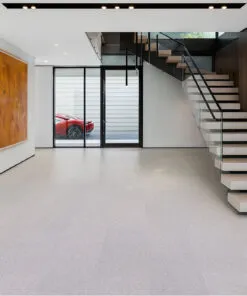 Modern entryway showcasing floating stairs with glass railing and soft neutral Grano cork flooring that adds warmth to a minimalist space.