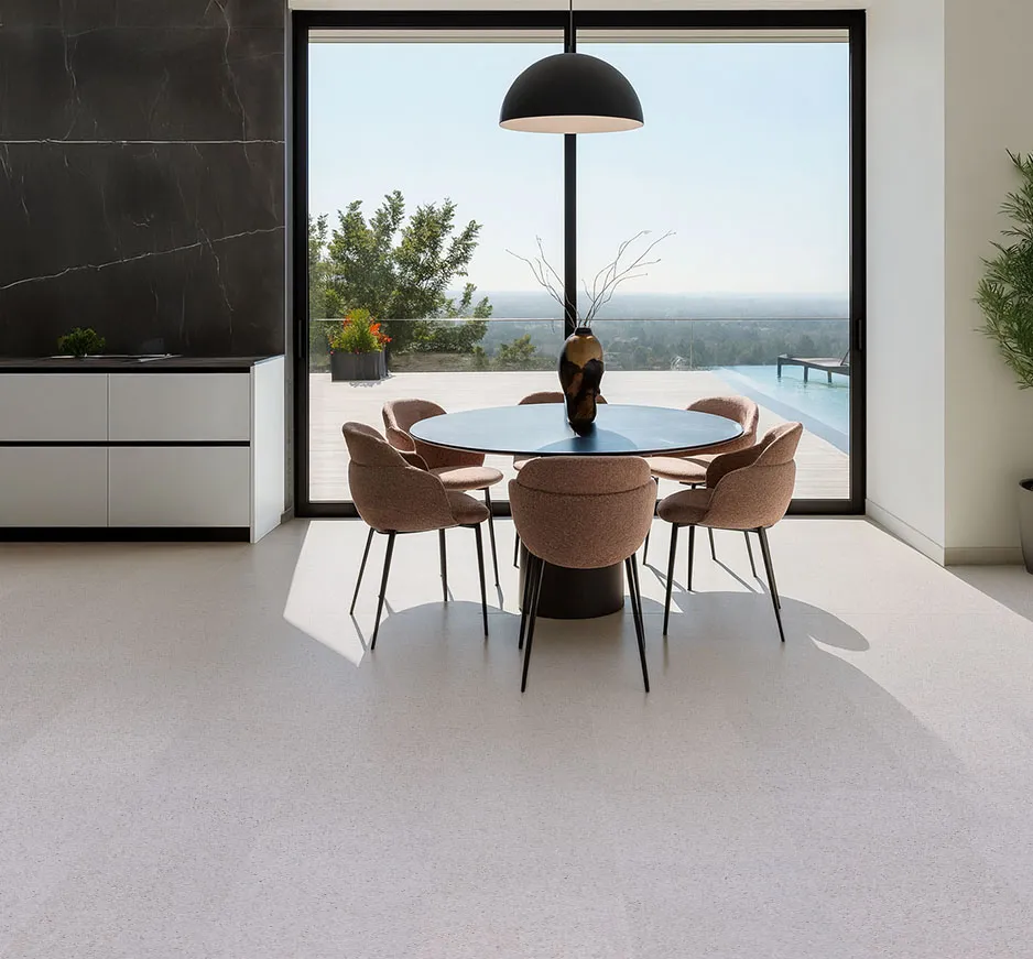 Bright dining area with floor-to-ceiling windows, elegant beige chairs, and warm Grano cork flooring that enhances the natural light and open feel.