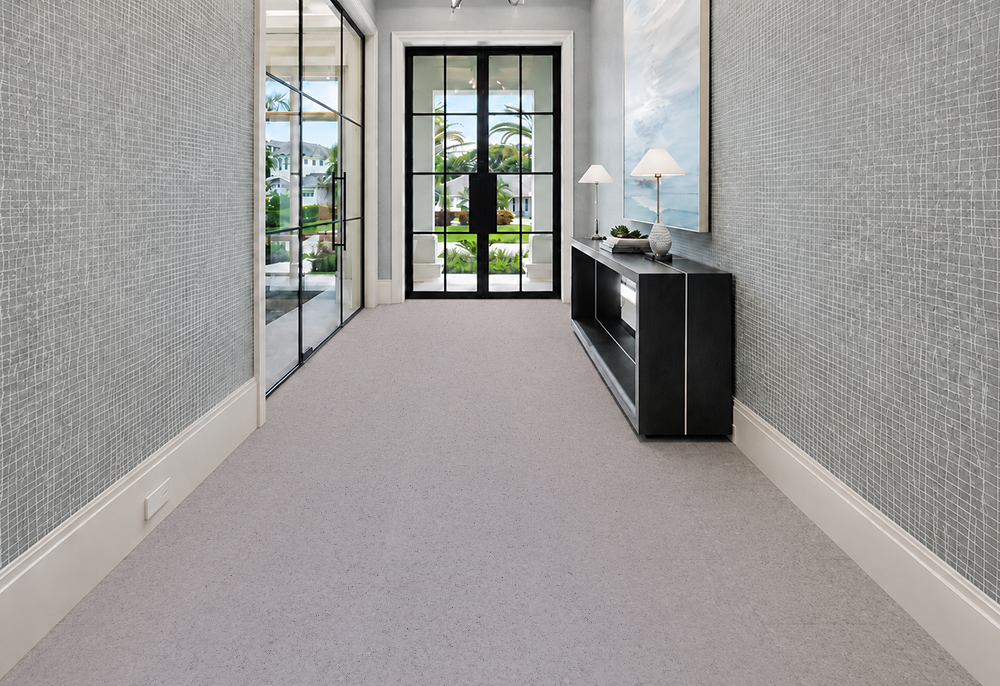 Grano - 25/64" (10mm) - Cork Floating (FGra10) Grano 10mm floating cork flooring with fine speckles extends through an entryway with a black console.