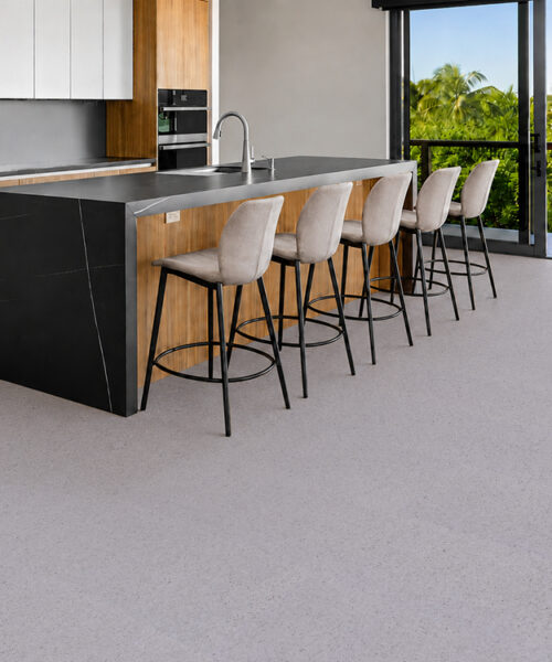Grano - 25/64" (10mm) - Cork Floating (FGra10) Pale Grano cork floor planks with organic grain surround a modern kitchen island and five stools.