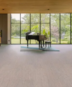 spacious music room with natural light and elegant gray bamboo cork flooring beneath a black piano
