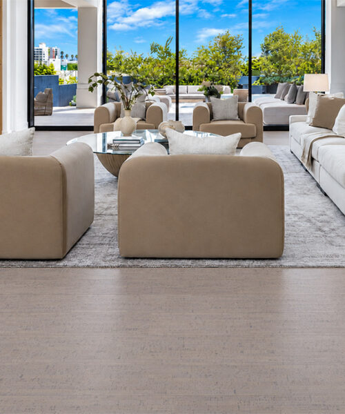 Gray Bamboo - 1/2" (12mm) - Cork Floating (FGB12) Gray Bamboo warm taupe cork flooring extends across a fireplace living room with cream seating and garden views.