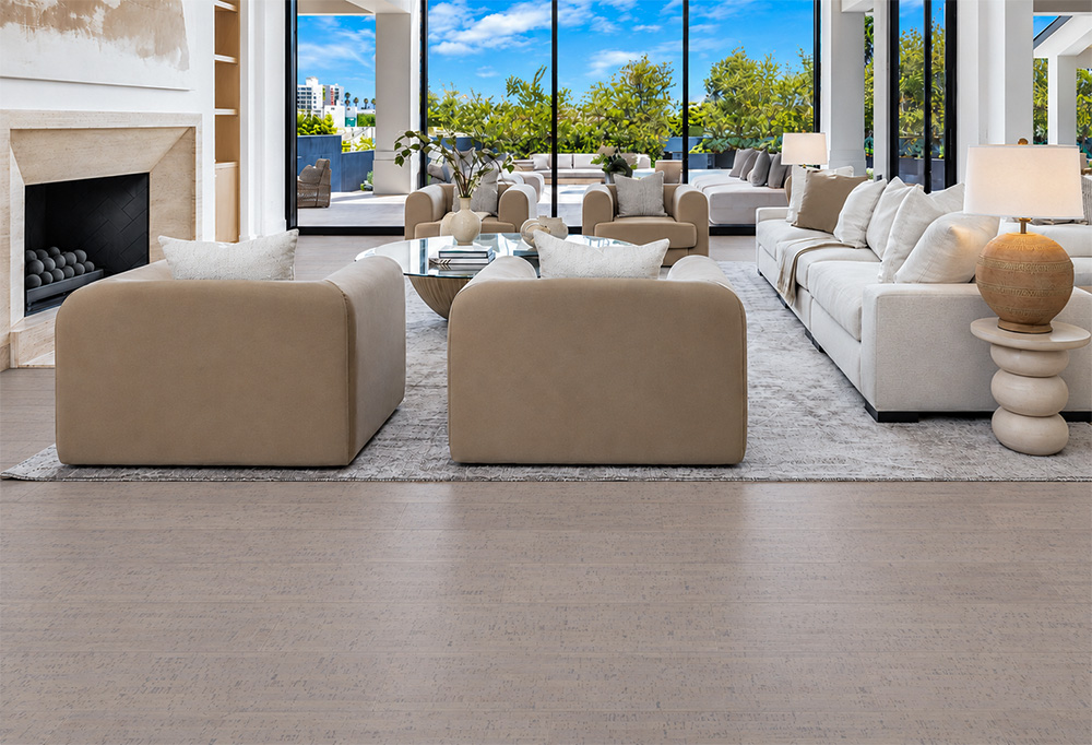 Gray Bamboo - 1/2" (12mm) - Cork Floating (FGB12) Gray Bamboo warm taupe cork flooring extends across a fireplace living room with cream seating and garden views.